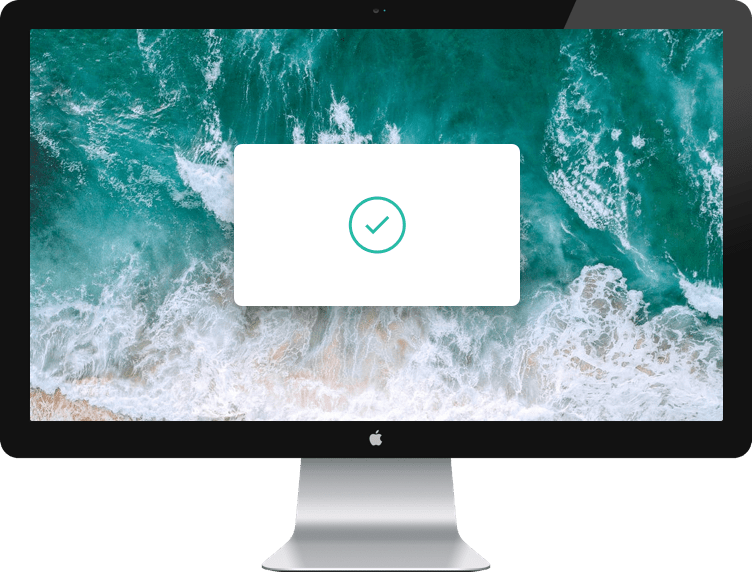 Image of mac monitor with a background of beach waves with a white modal window and a green check with a circle.